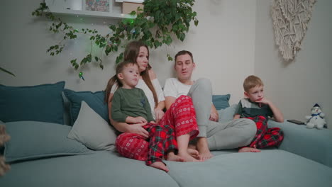Family-Watching-Tv.-Family-With-Children-Sitting-On-Sofa-In-Living-Room.-High-quality-4k-footage